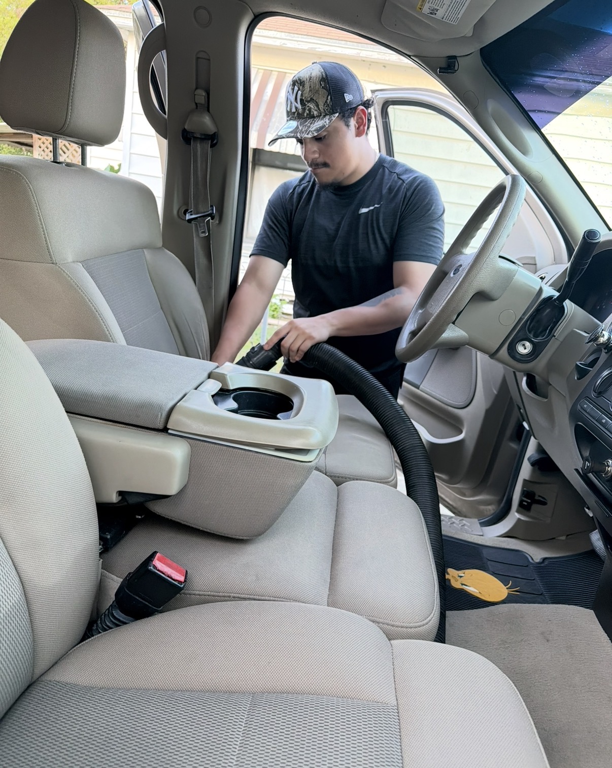 Lot Legends detailer cleaning the interior of a truck